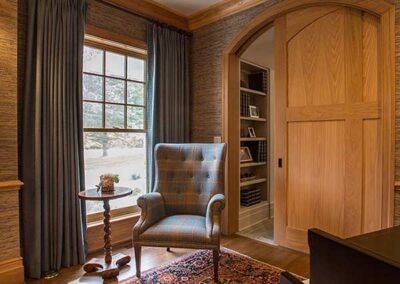 Dark window treatment in a wood panelled room