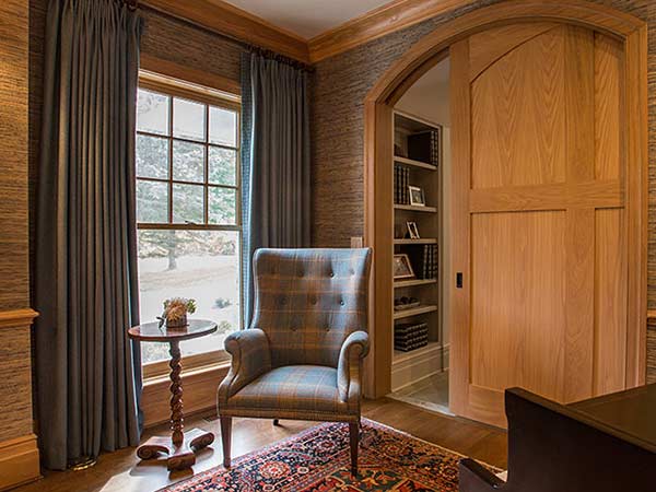 Dark window treatment in a wood panelled room