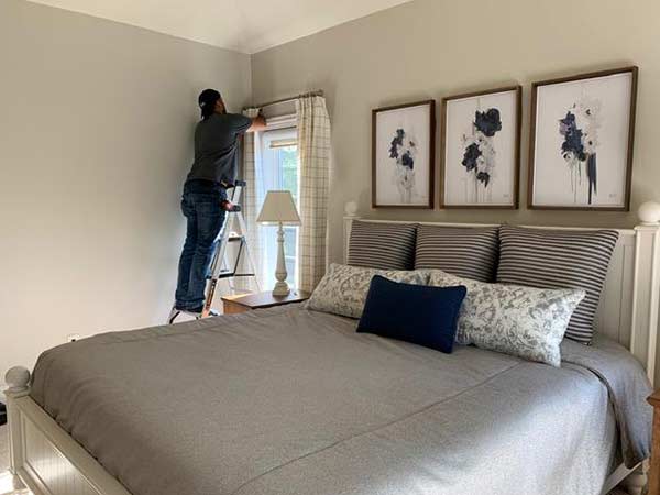 Installation of window treatments in a bedroom