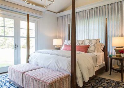 A bright window treatment behind a bed