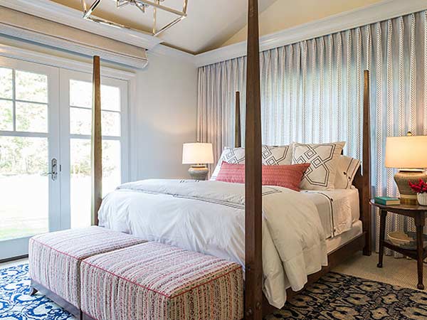 A bright window treatment behind a bed