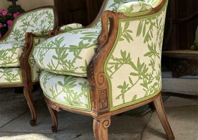 chairs upholstered with a white and green floral pattern