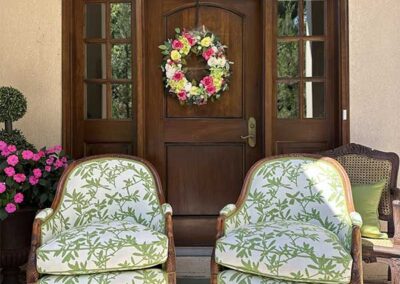 two chairs upholstered with a white and green floral pattern