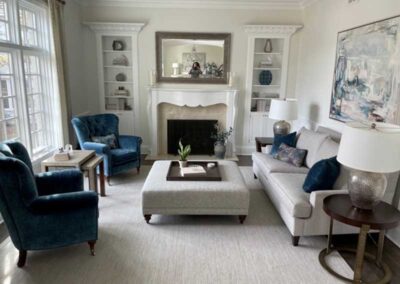 A living room set with blue upholstered chairs and white sofa