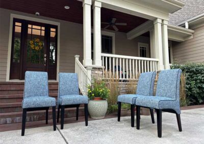 four blue upholstered chairs on display outside