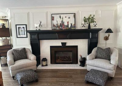 two upholstered chairs on either side of a fireplace